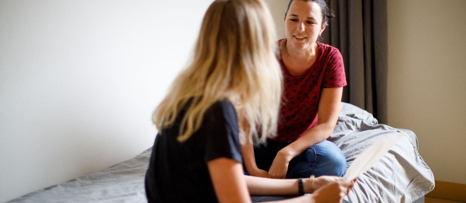 Begeleider en jonge vrouw zijn aan het praten samen